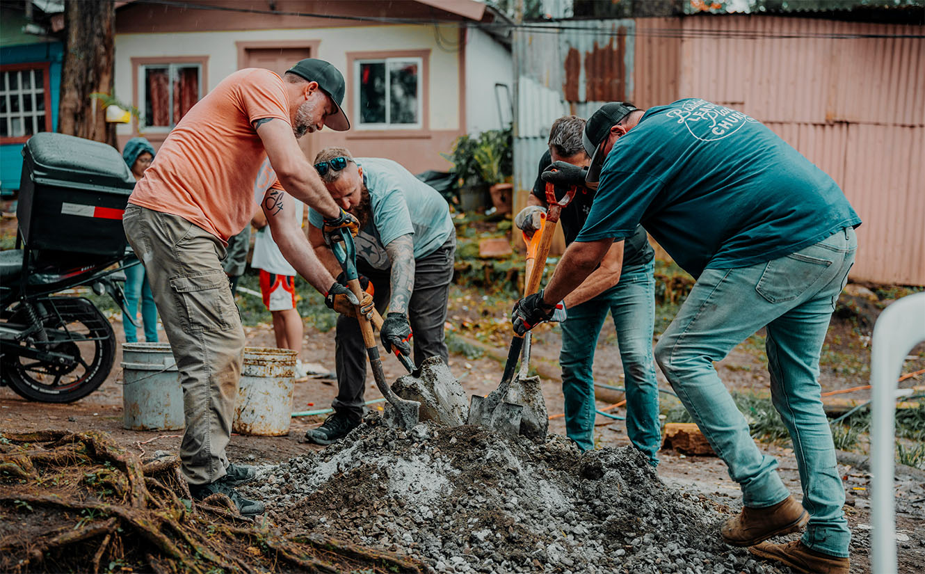A team of people doing construction in a barrio in Costa Rica.