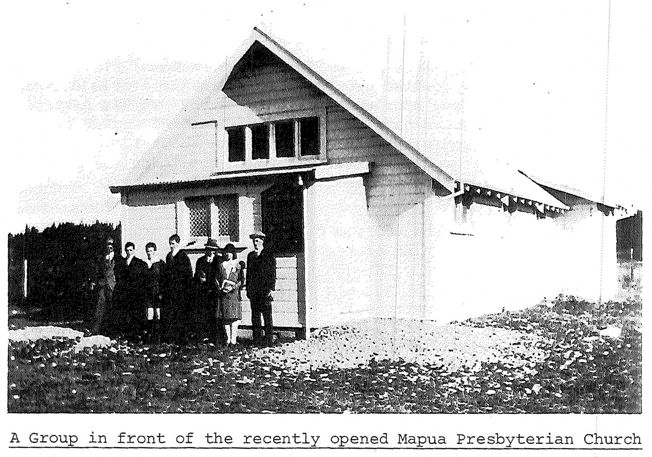 An old black-and-white image of a group in front of the recently opened Mapua Presbyterian Church.