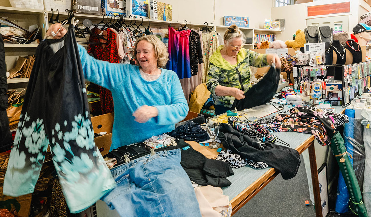 People sort clothes at the Sharing Shed op shop in Cobden.