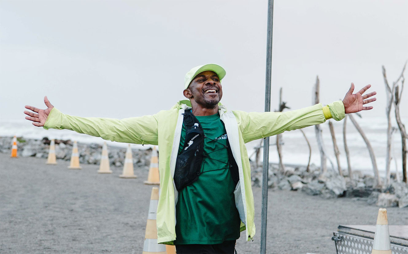 Bishop Steve Maina crosses the South Island Ultra finish line on the Hokitika coastline