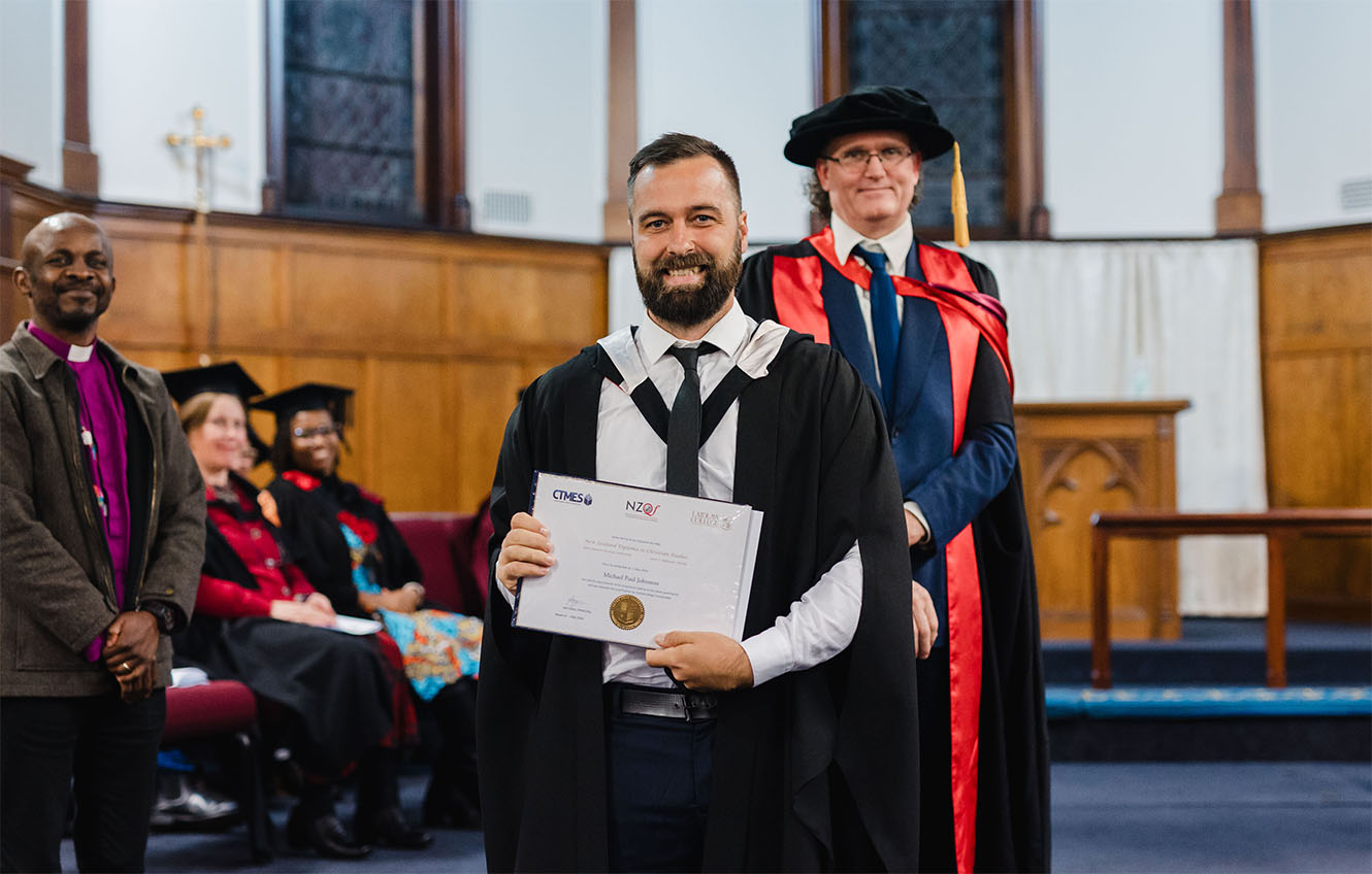MJ holding his certificate from Bishopdale College at the graduation ceremony