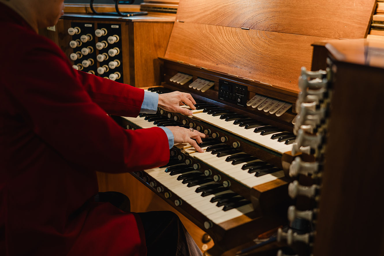 A man playing the organ in Nelson Cathedral