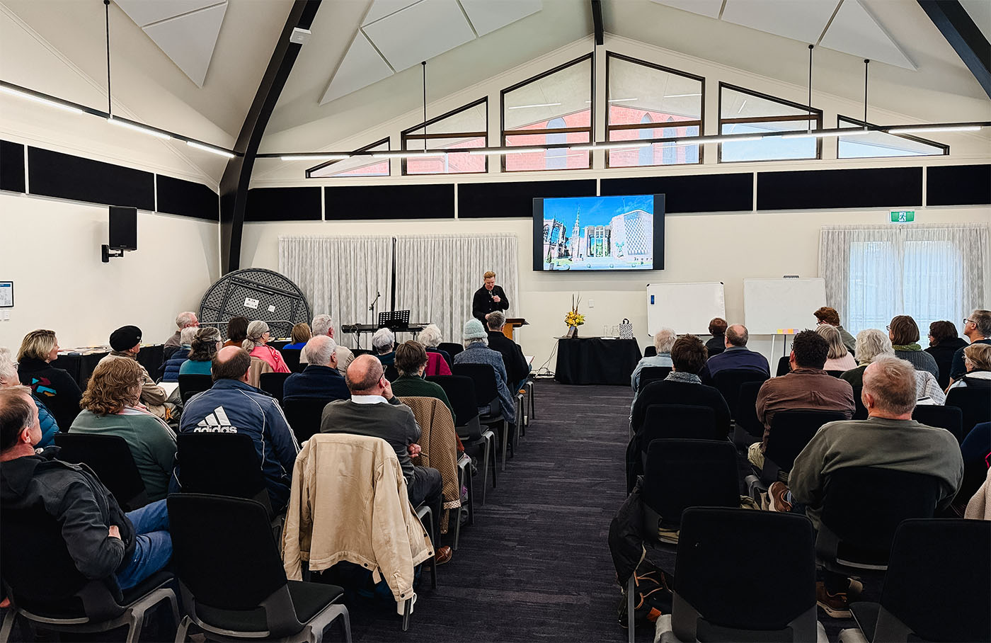 A wide shot of Clint Ussher speaking to Anglicans at Emmaus 2026
