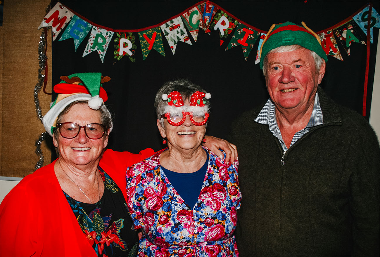 people smiling in the Christmas photobooth