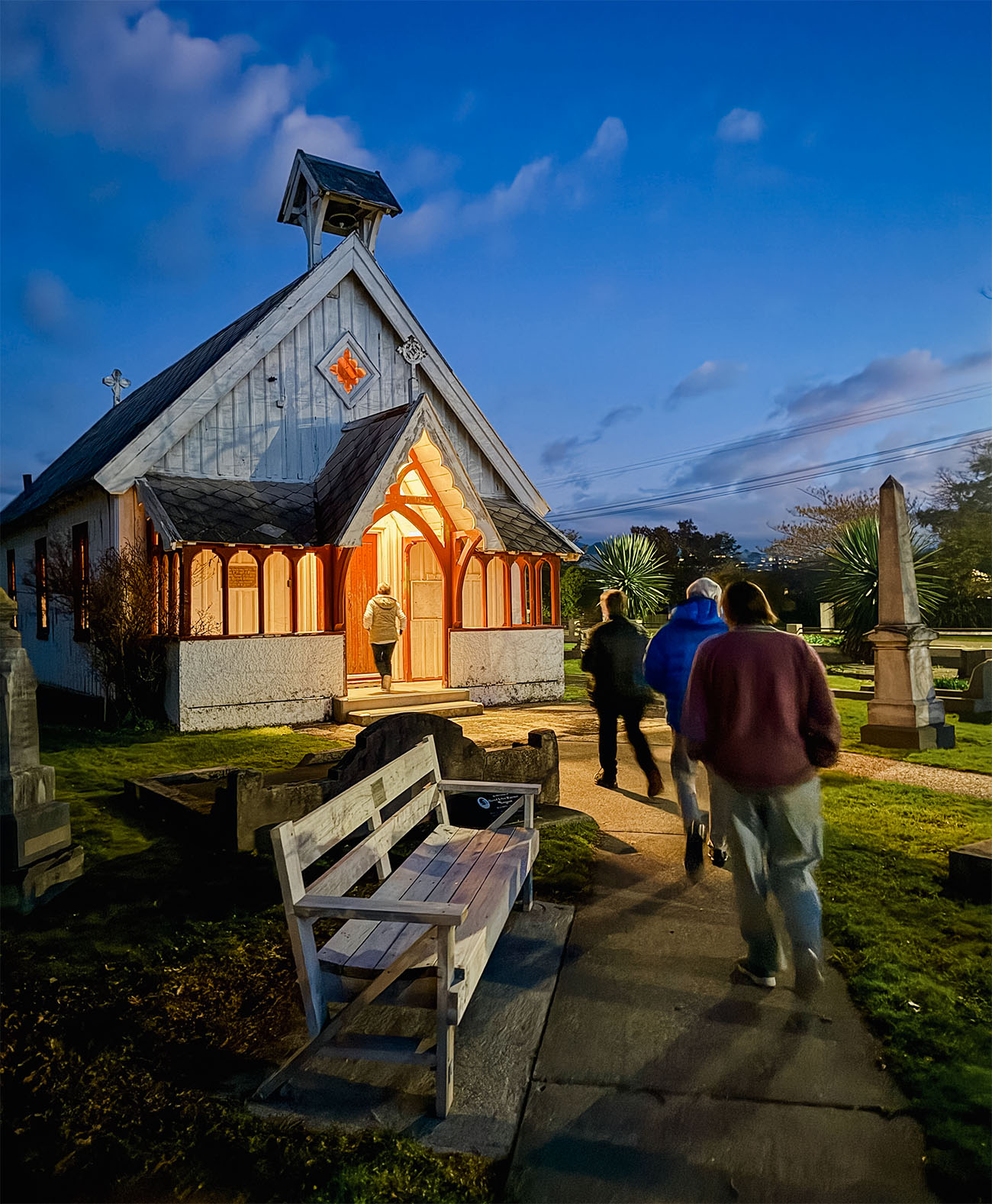 people heading towards the St Paul's chapel building at twilight