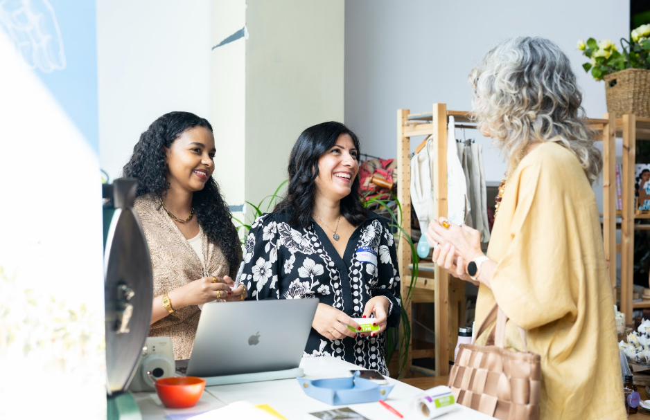 Three women standing together and smiling