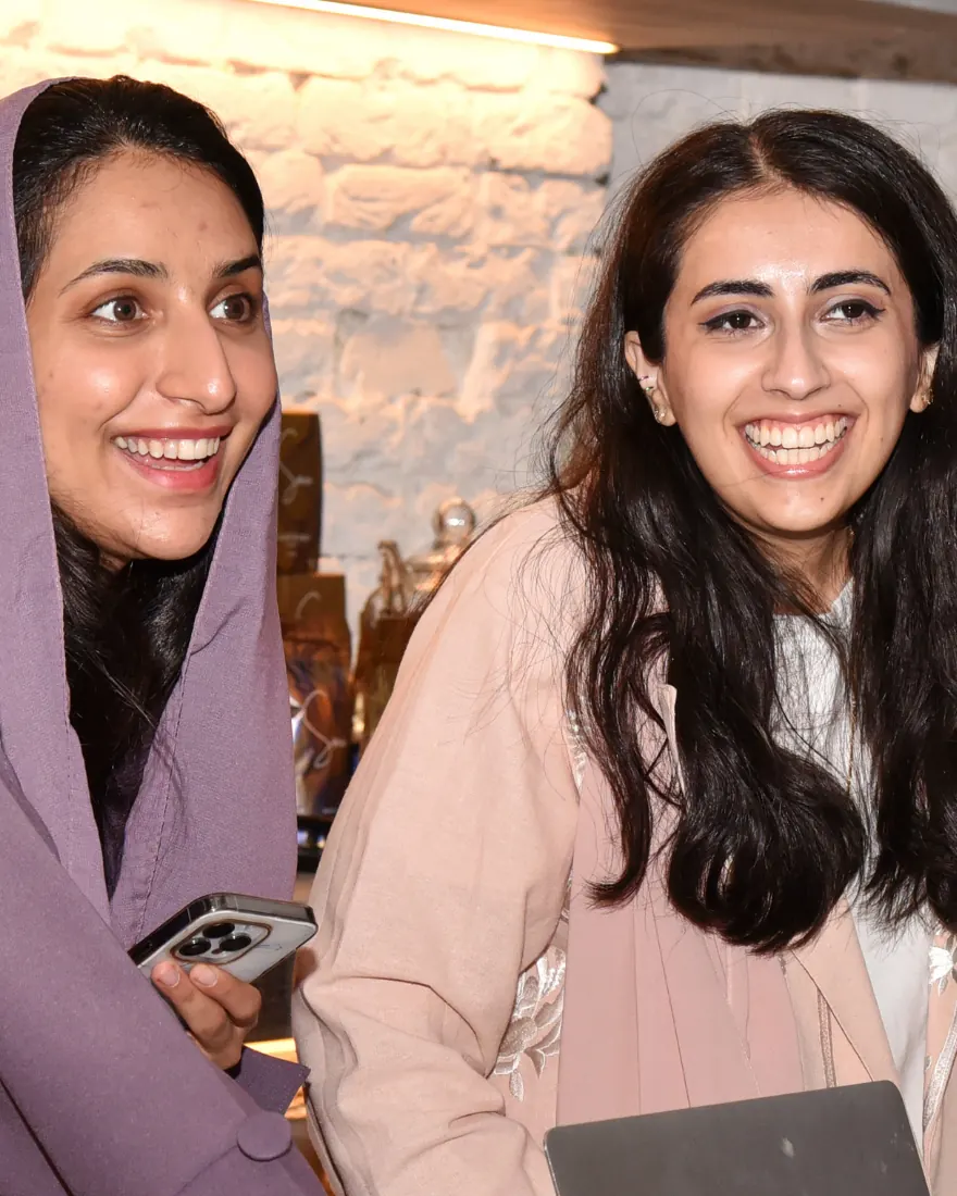 Two members laughing together at a PLAYBOOK gathering.