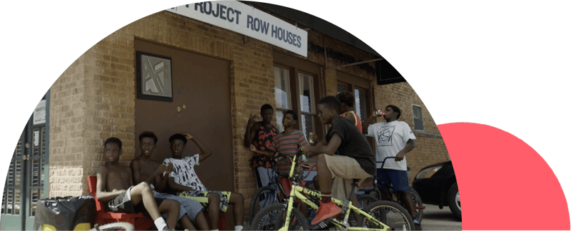 Older children sit on benches and bicycles outside a brick building. Photograph with illustration layered over it