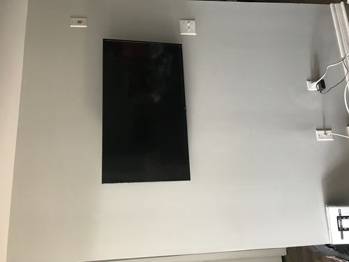 A TV installed into metal studs in an apartment building