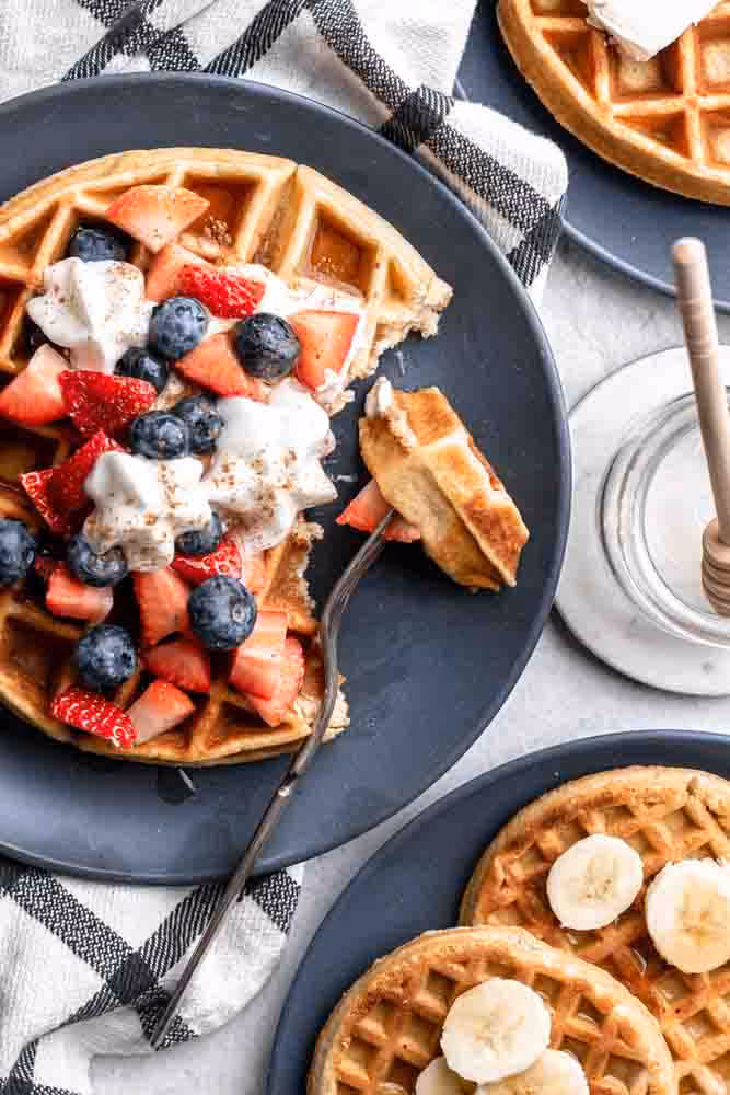 A half eaten waffle on a plate