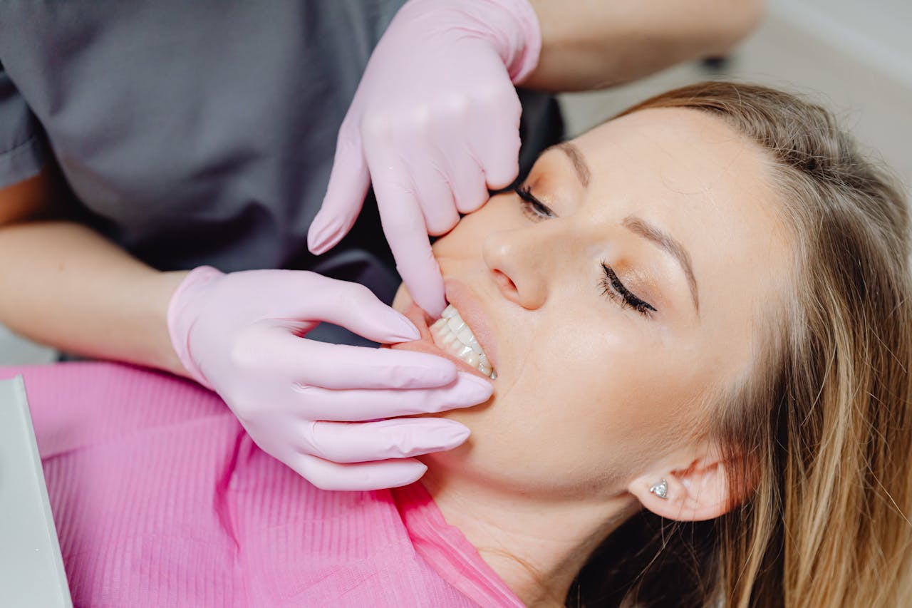 A dental patient looking at her teeth in a mirror