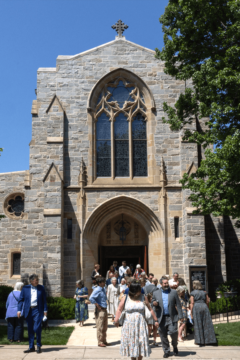 Church exterior with people exiting the church