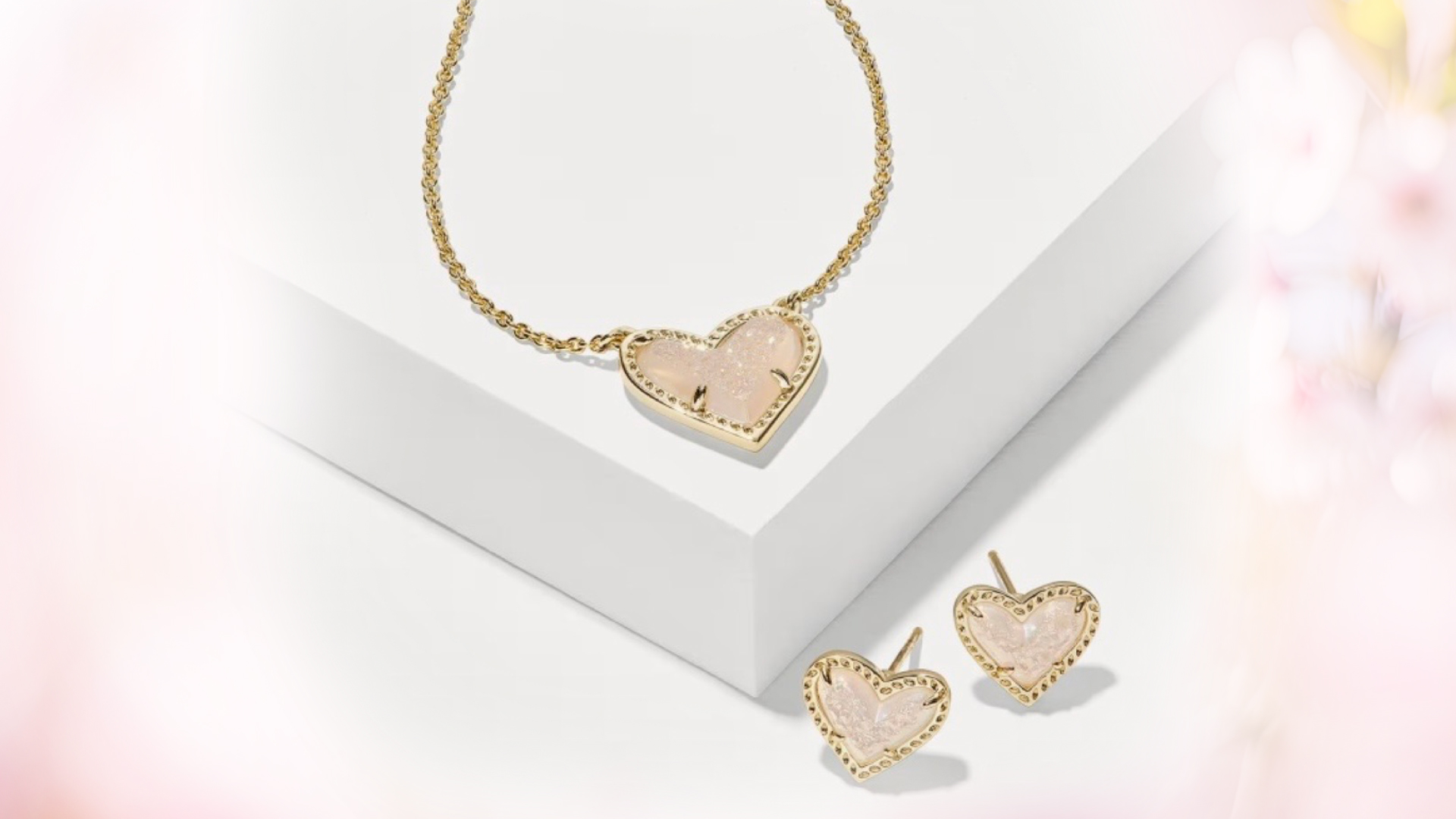 Gold heart-shaped necklace and earring set with pink sparkling stone inlays for a casino gift giveaway