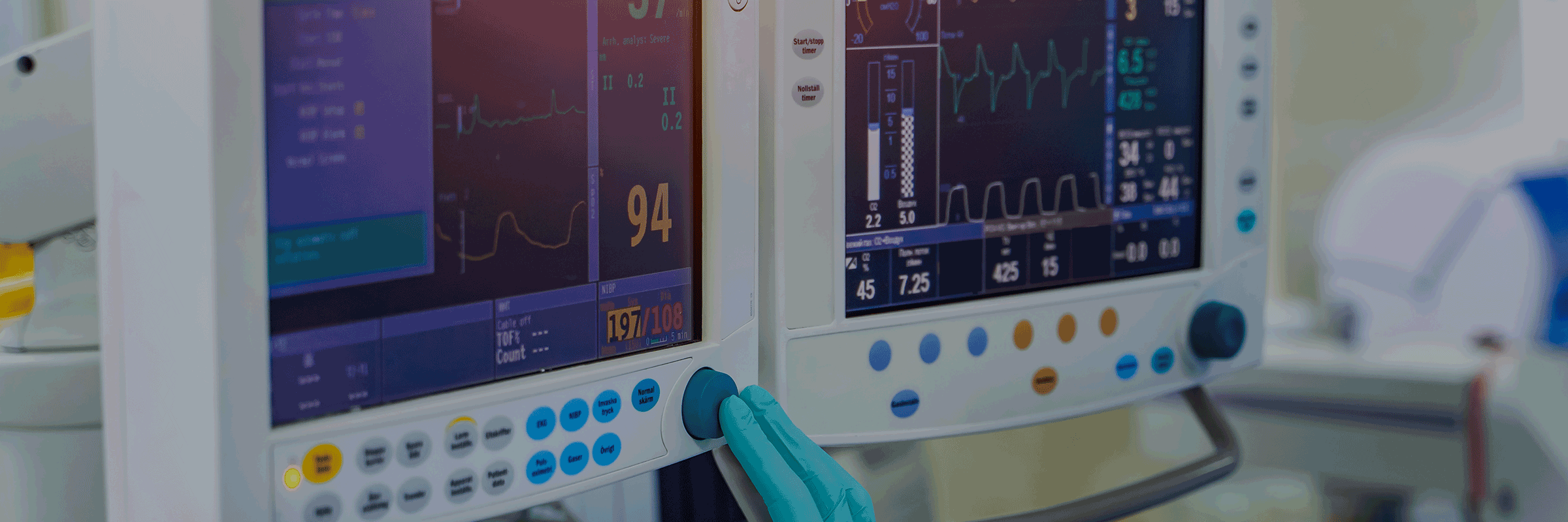 A healthcare worker reviewing information on monitor