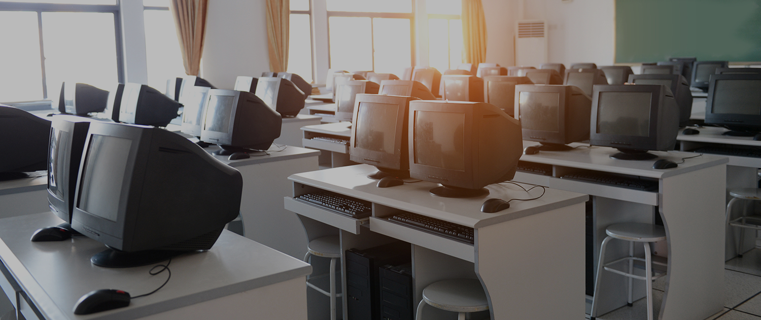 A healthcare worker reviewing information on monitor