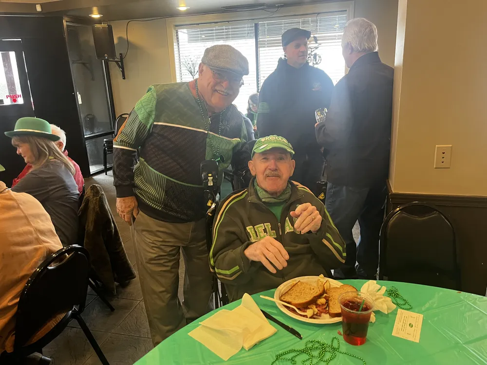 River Grove Lions Club members in green attire celebrating St. Patrick's Day at the annual community dinner