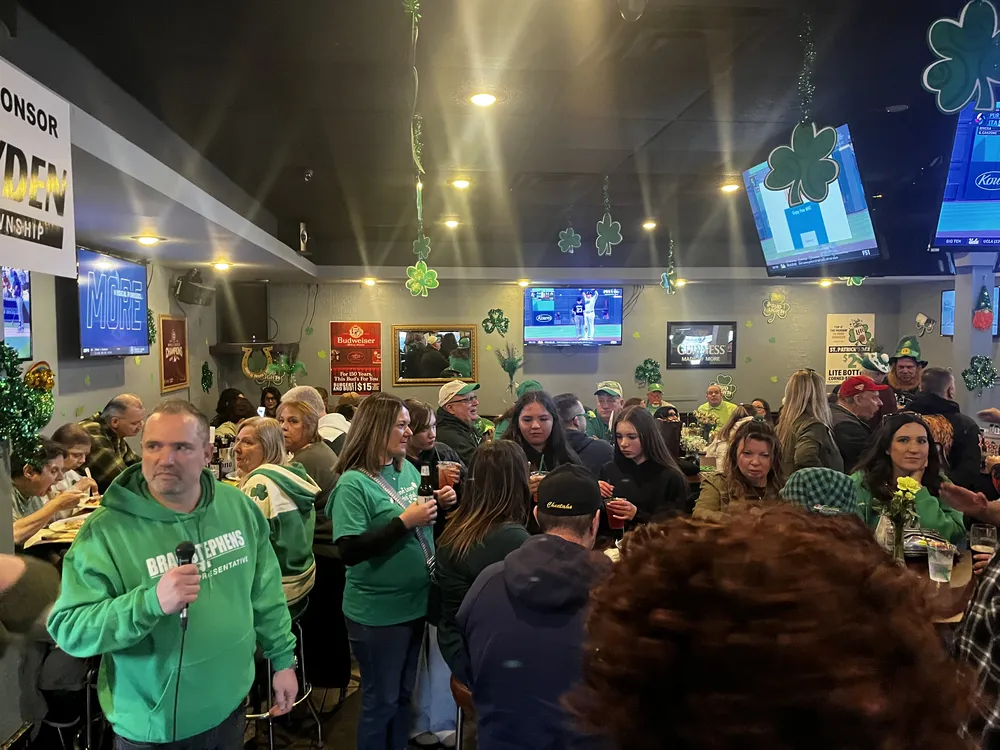 River Grove Lions Club members gathered at tables celebrating St. Patrick's Day dinner at the Underpass Lounge