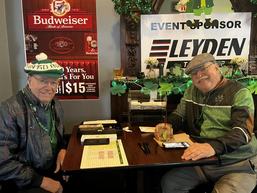 River Grove Lions Club members seated together celebrating St. Patrick's Day at the Underpass Lounge fundraiser