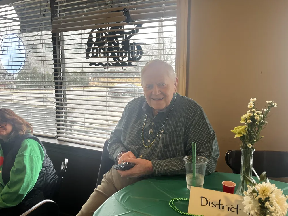 River Grove Lions Club members smiling and toasting at the St. Patrick's Day dinner and raffle fundraiser