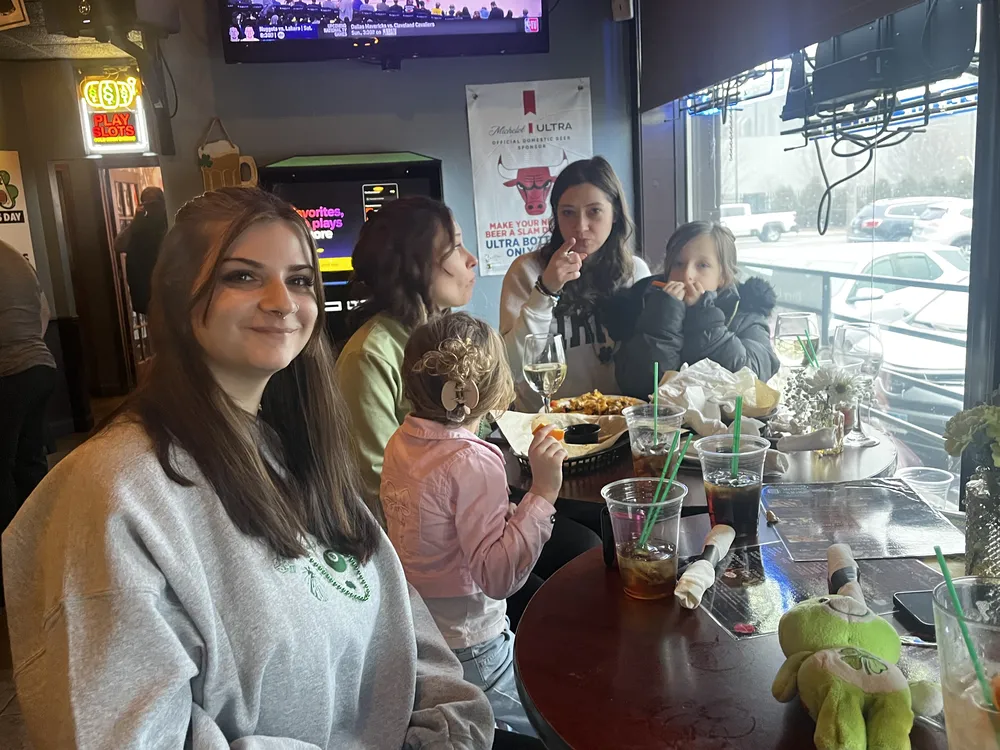 River Grove Lions Club members gathered at a dinner table wearing festive green for St. Patrick's Day