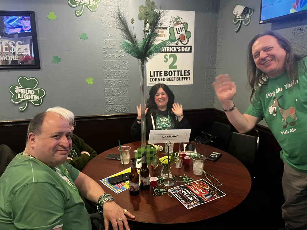 River Grove Lions Club members laughing and socializing at the St. Patrick's Day dinner