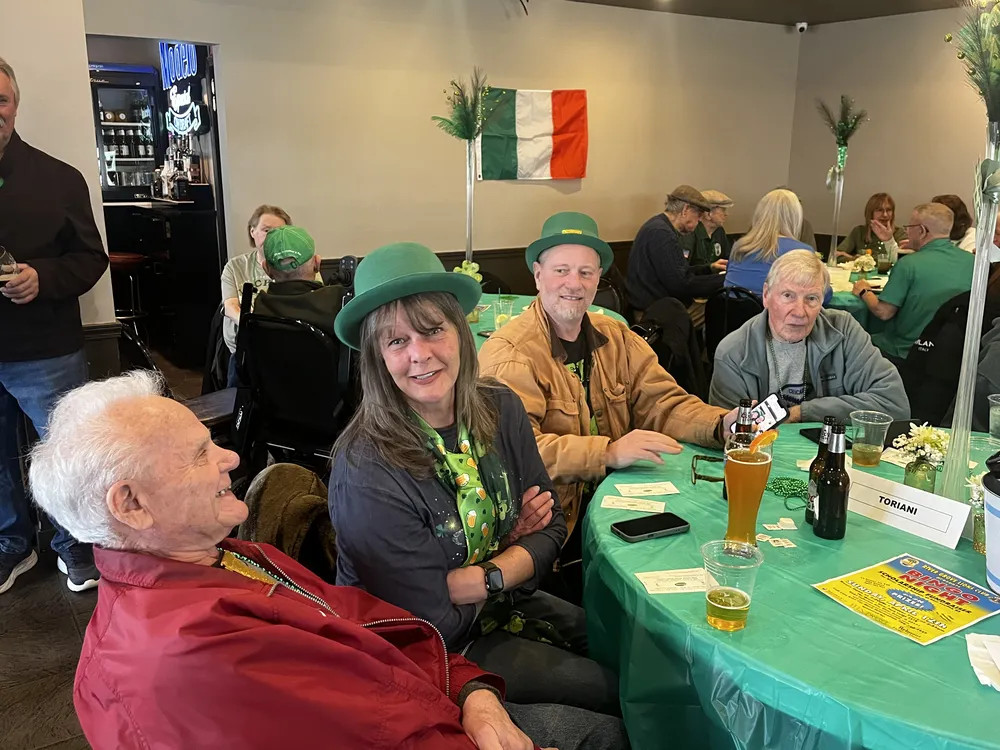 River Grove Lions Club members posing and laughing at the annual St. Patrick's Day corned beef and cabbage dinner
