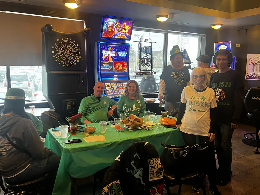 River Grove Lions Club members posing together in green during the St. Patrick's Day dinner and raffle