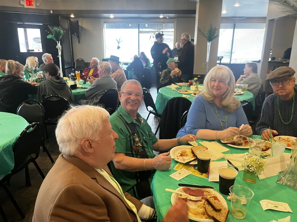 River Grove Lions Club members gathered and smiling at the St. Patrick's Day dinner and raffle fundraiser