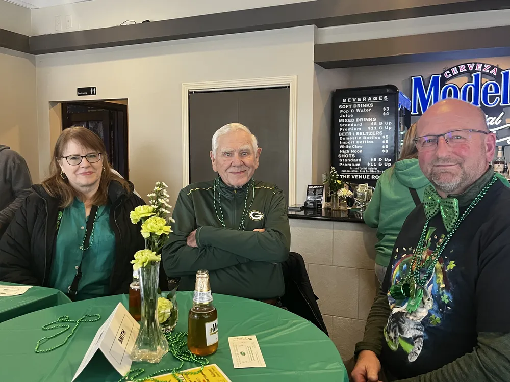 River Grove Lions Club members gathered at tables with festive green decorations for the St. Patrick's Day event