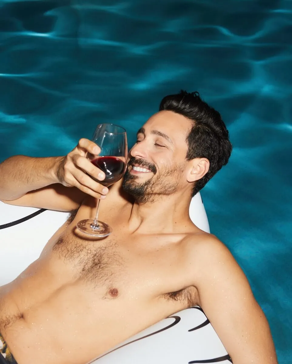 Man enjoying a drink in the pool