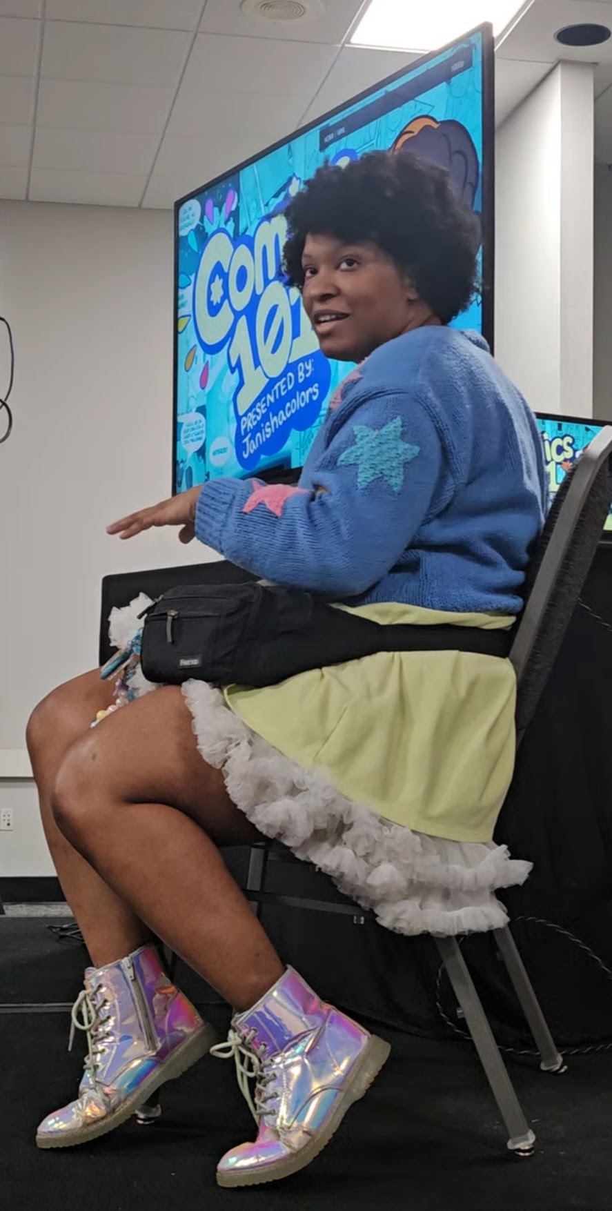 Young Woman with black curly hair happily writing in a journal