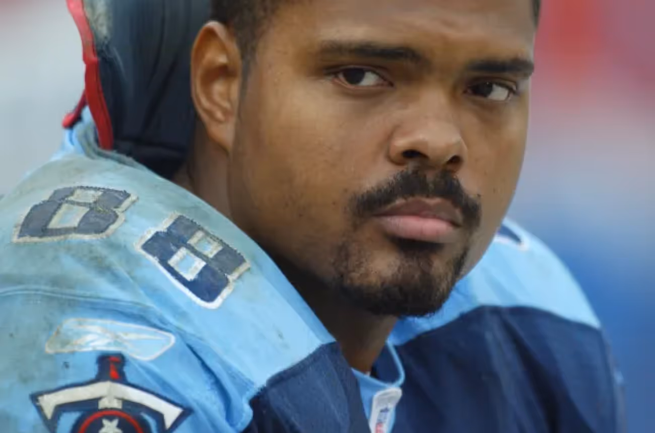 Erron Kinney, former Tennessee Titans tight end, wearing his #88 jersey on the sidelines during an NFL game, looking focused and determined.