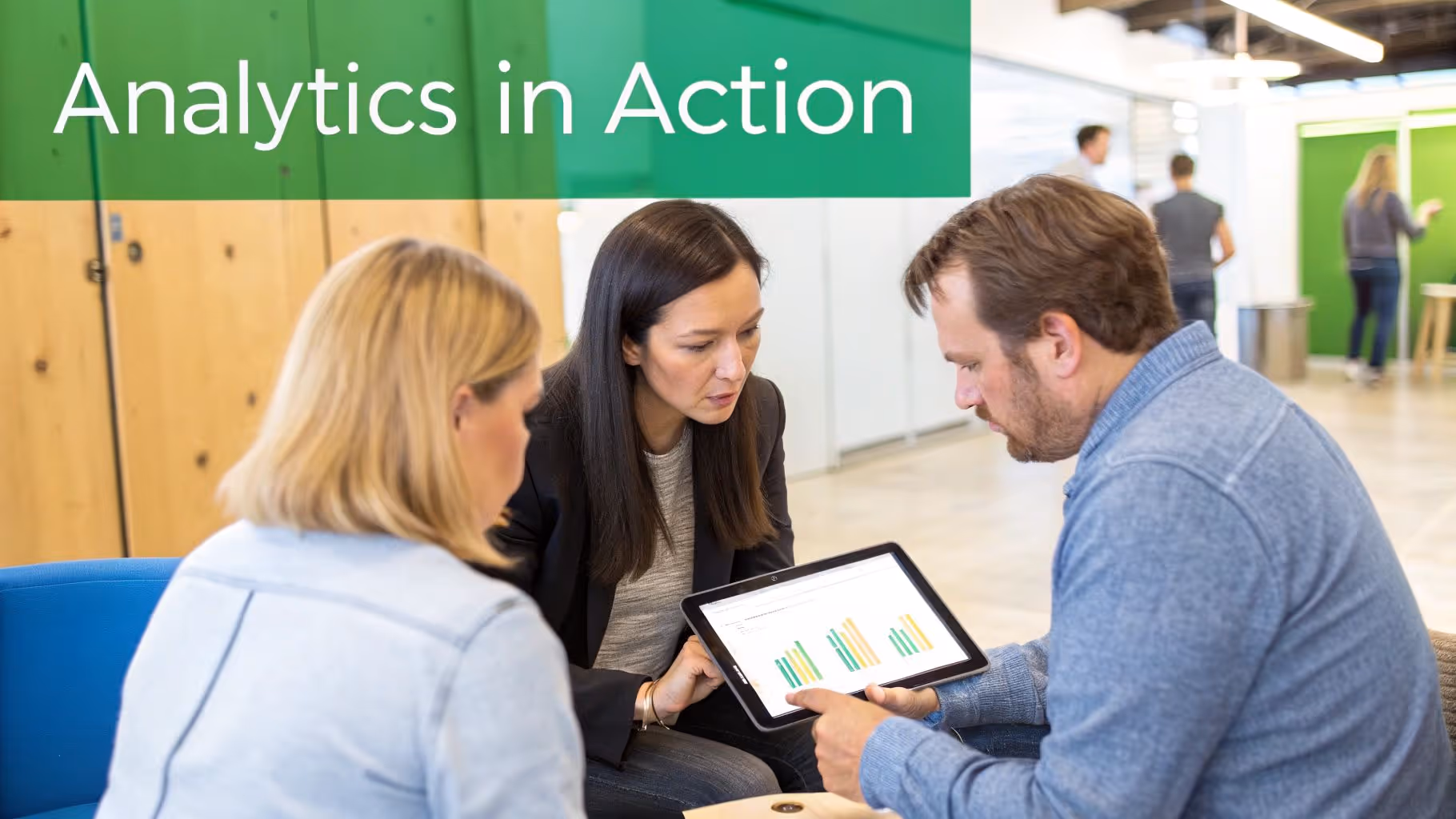 Three business professionals reviewing data analytics and bar charts on a tablet in a modern office.