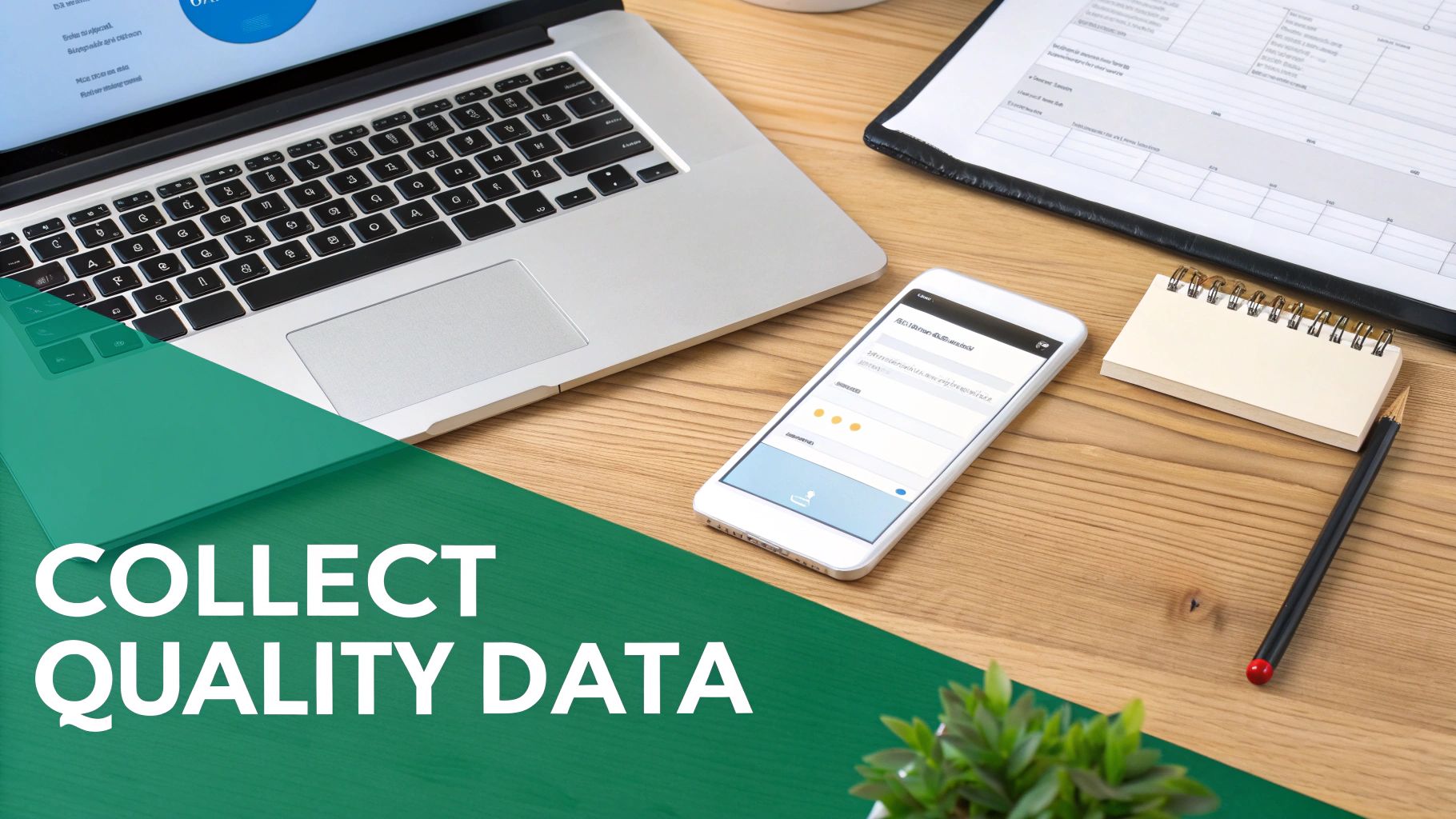 Overhead view of a desk with a laptop, smartphone collecting quality data, notepad, and pen.