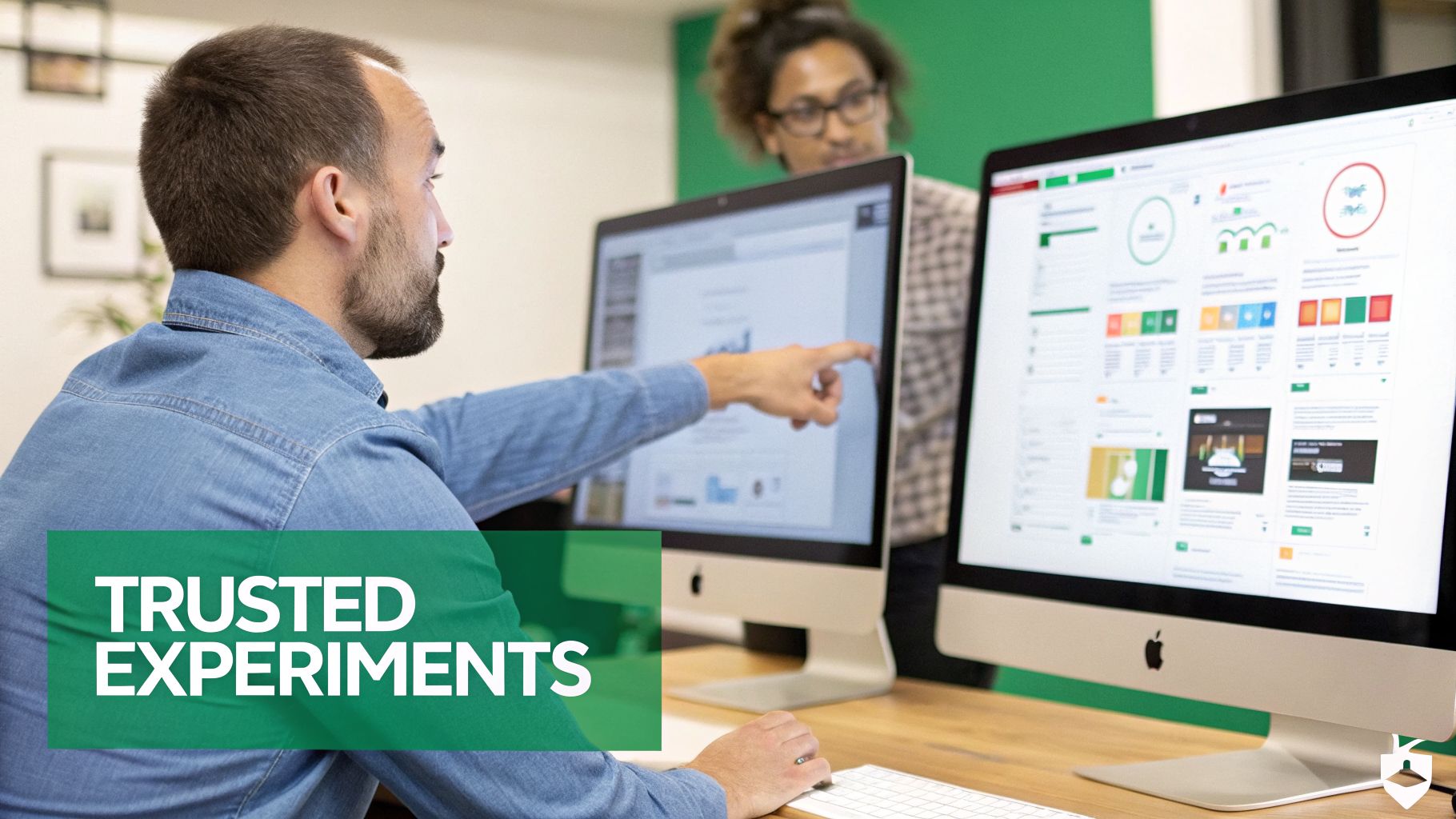 Two professionals analyze data and experiment results on iMac computers in a modern office setting.