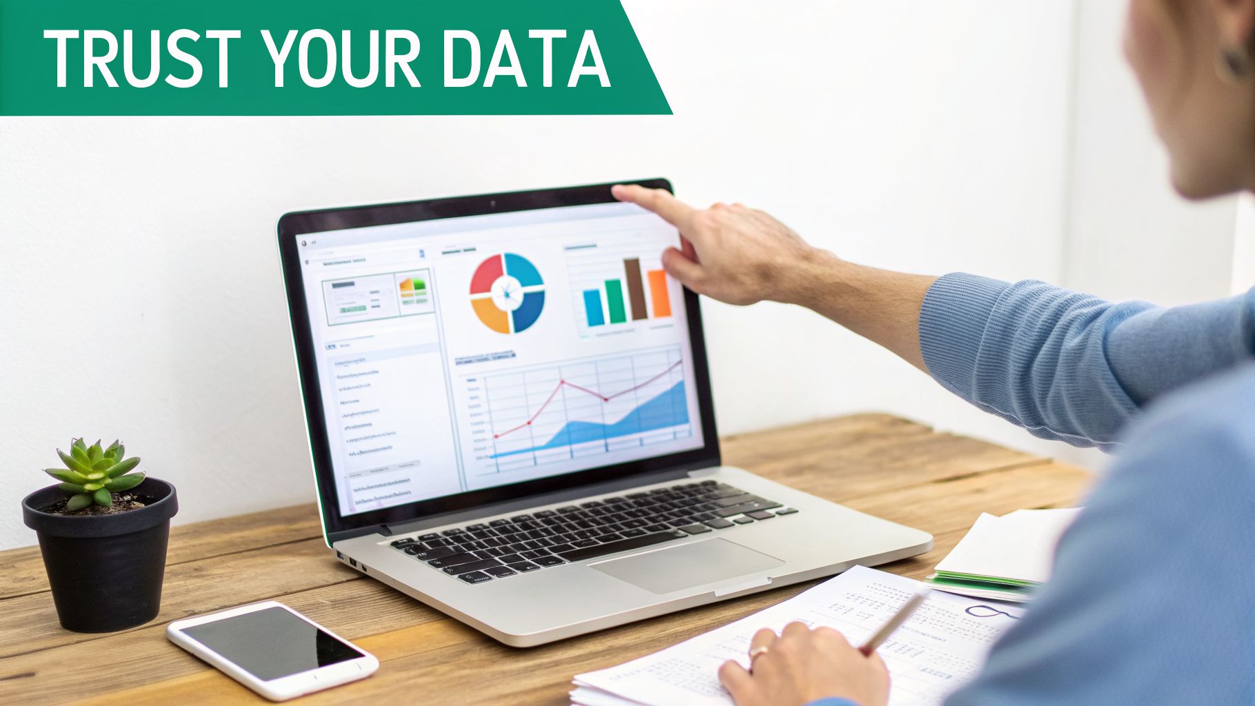 A person's hand points at a laptop screen showing various data visualizations and charts.