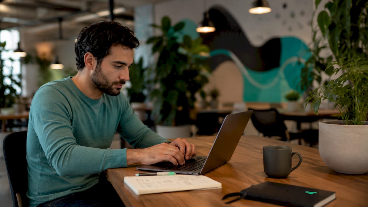 Man working on laptop integrating data