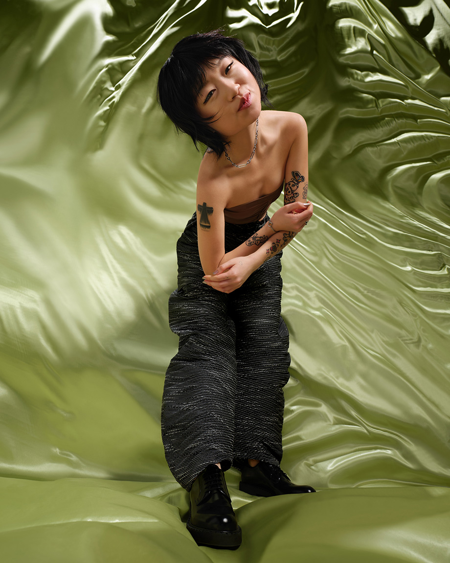Person with tattoos on green background