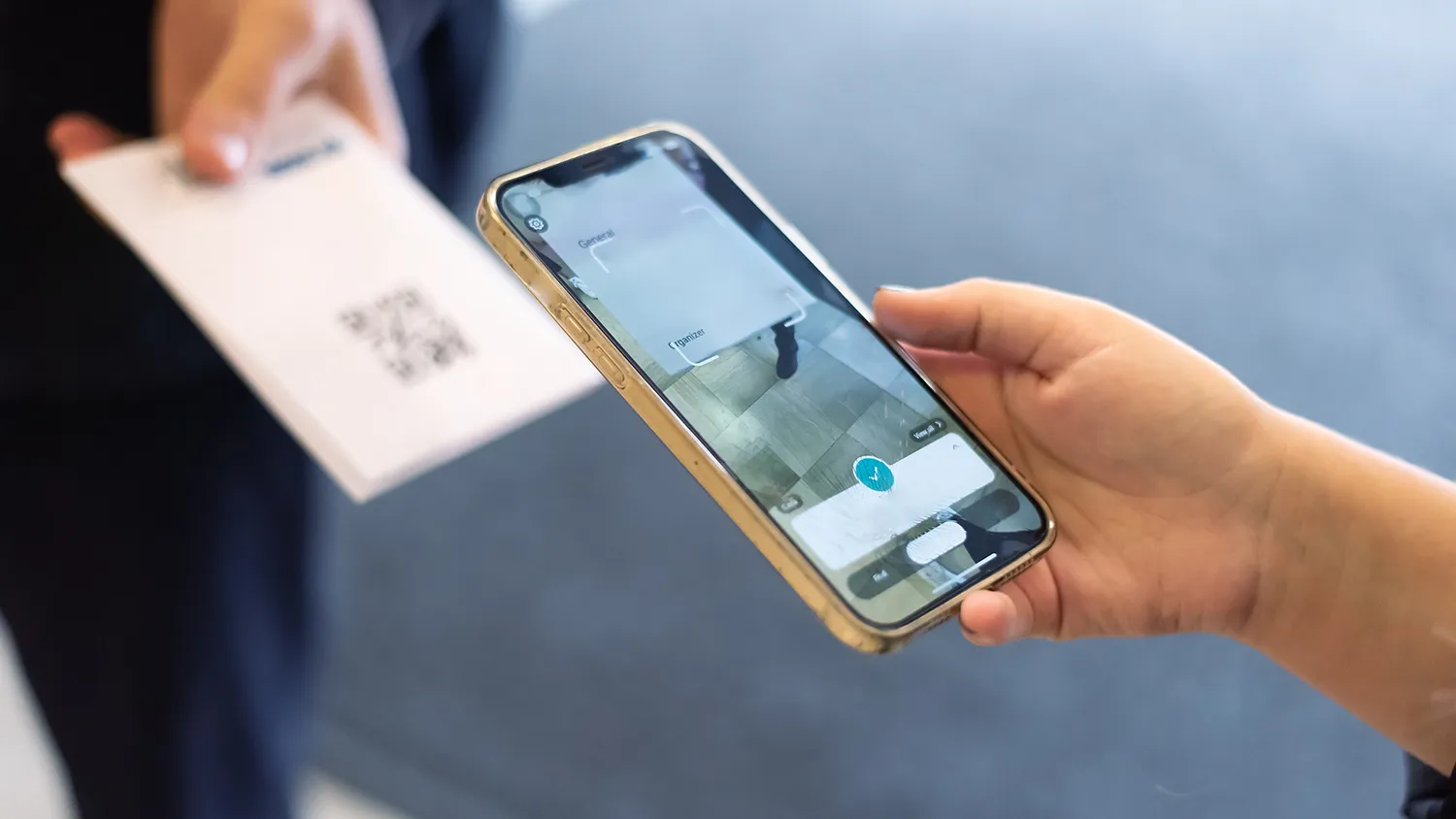 Marketer scanning a badge QR code at a conference booth to capture a lead on a mobile app