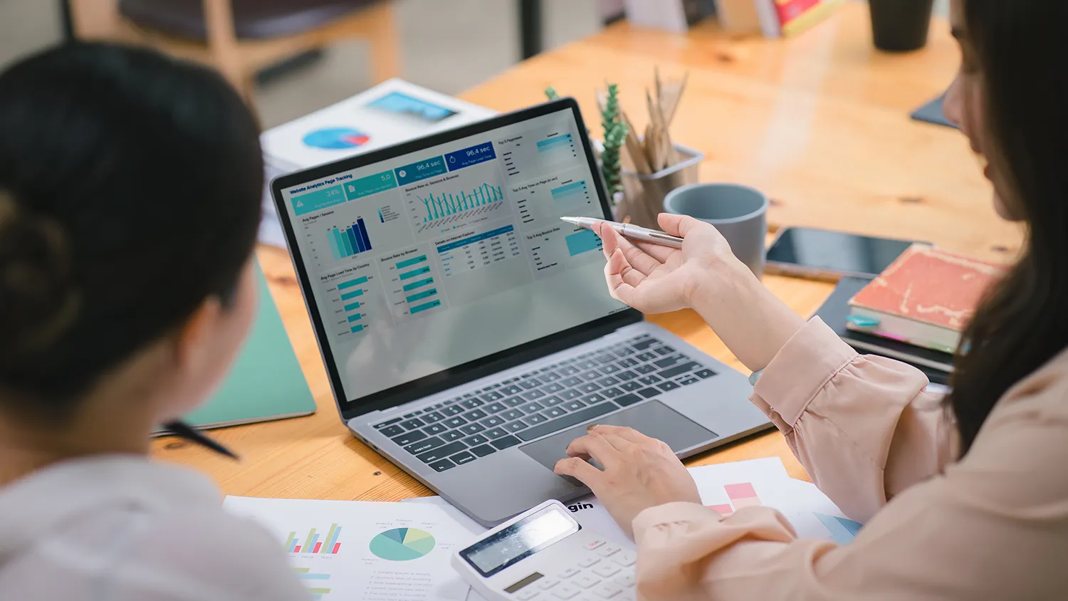 Planner reviewing sponsor analytics dashboard with live exhibitor portal and cross-event reporting in an event software platform.