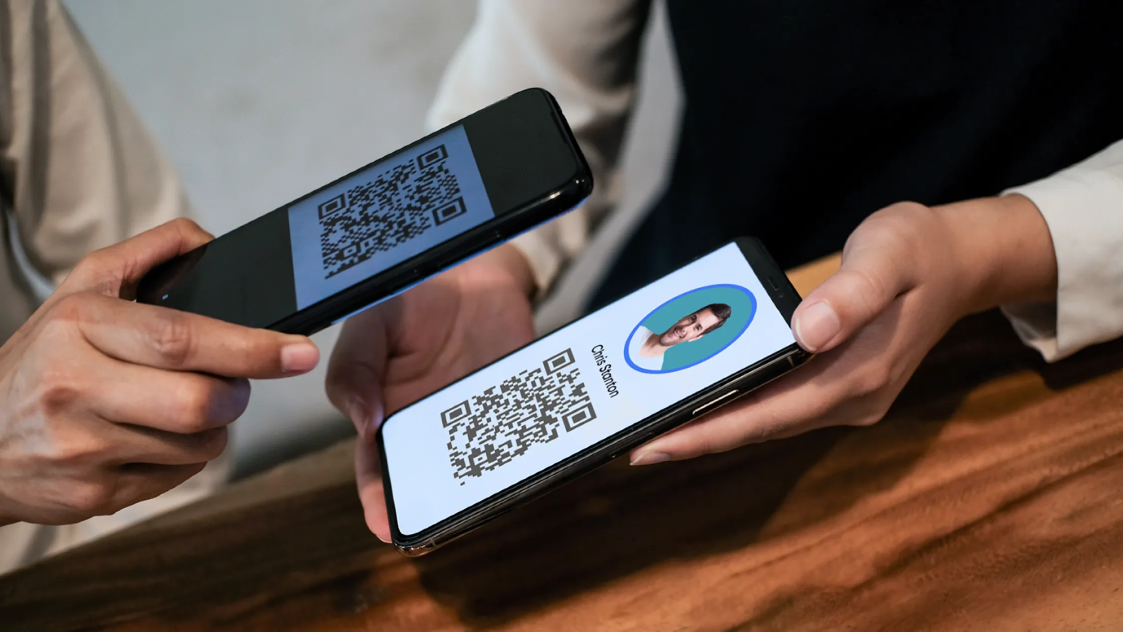 Booth scene showing a rep scanning a badge, adding a note on a phone, and a monitor displaying real time lead totals and meeting counts.