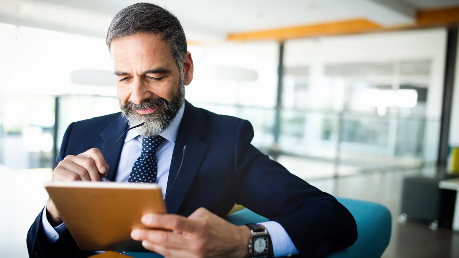 Corporate executive on a tablet computer choosing event management software options