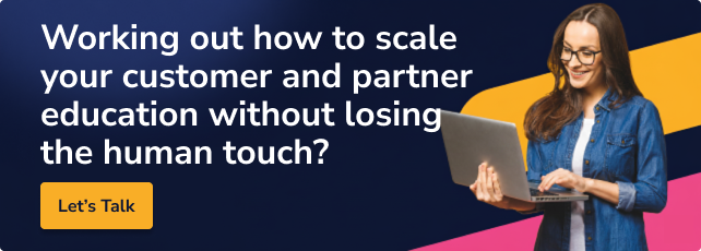 A modern marketing banner showing a smiling professional woman using a laptop, promoting scalable customer and partner education with a human touch, featuring the text: “Working out how to scale your customer and partner education without losing the human touch? Let’s talk.”