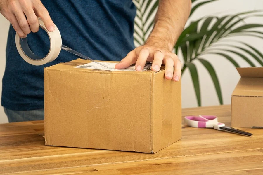 A shipping label being applied to a sealed parcel