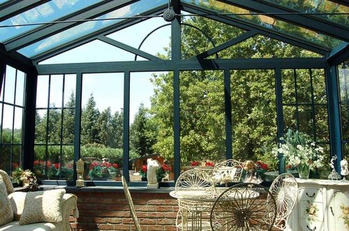 Inside a bright and airy conservatory with dark grey framing