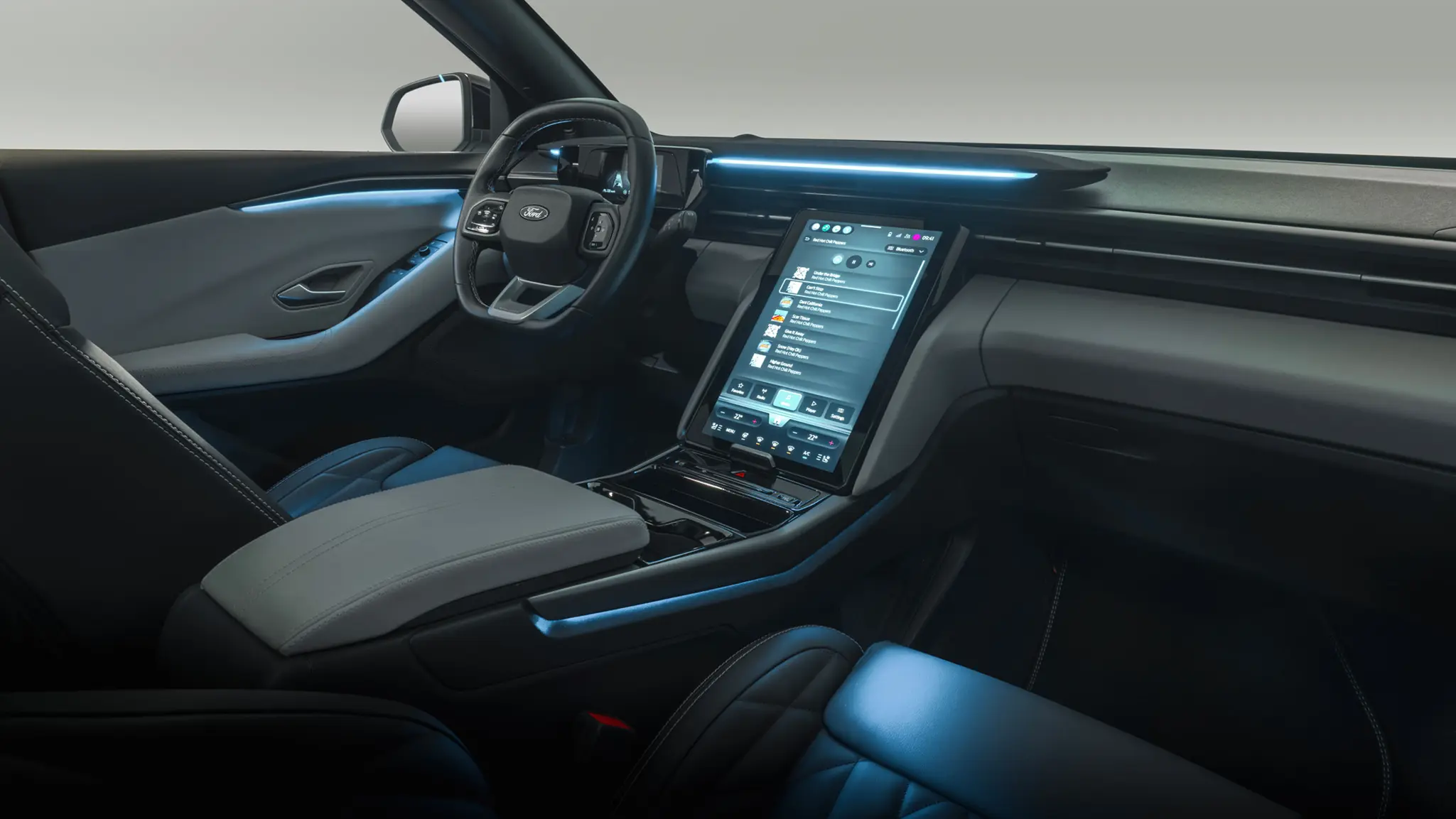 Ford Explorer EV interior with the portrait touchscreen centerstack and ambient light strip across the dashboard