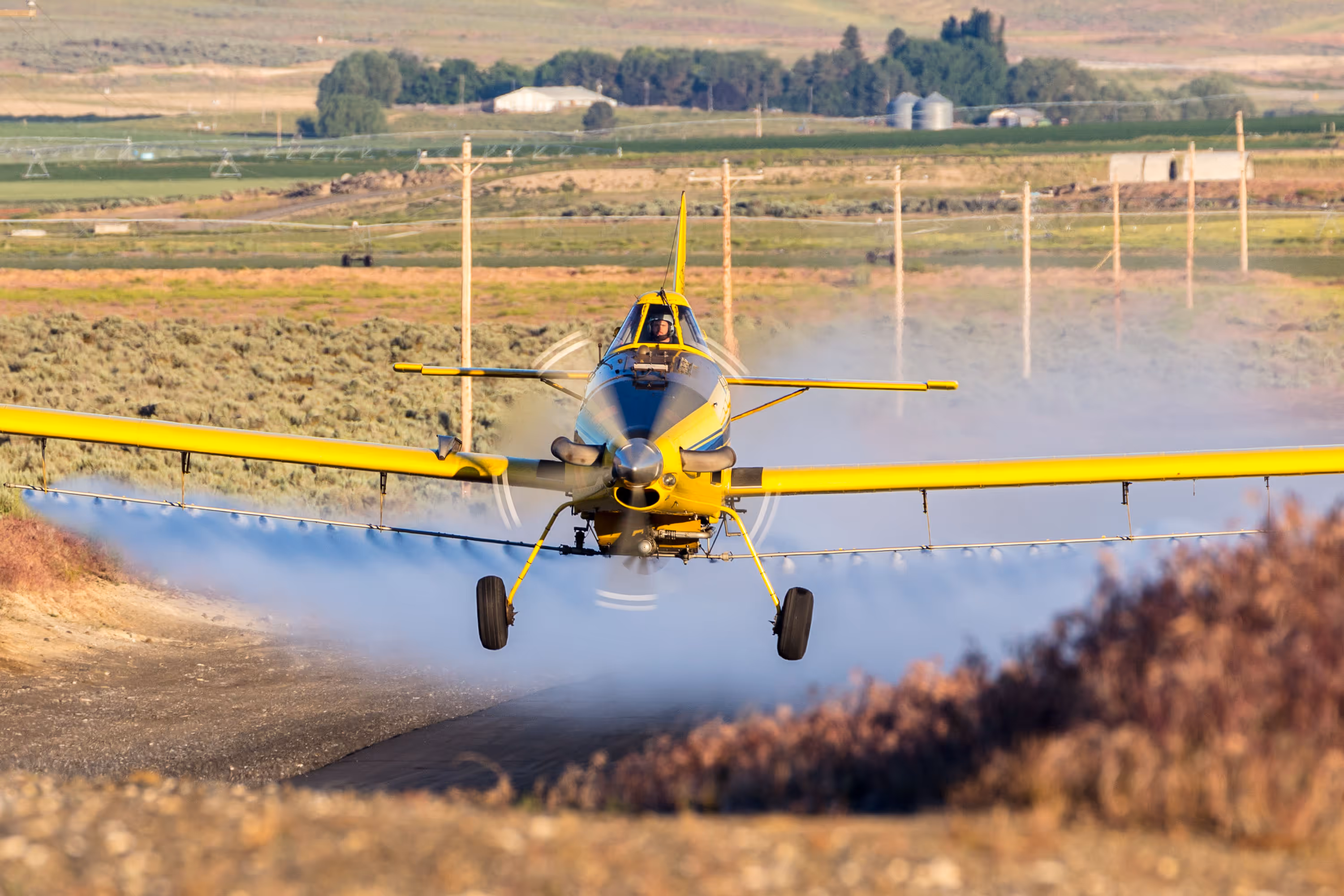 Crop dusting aircraft taking off from rural runway, Warden, Washington