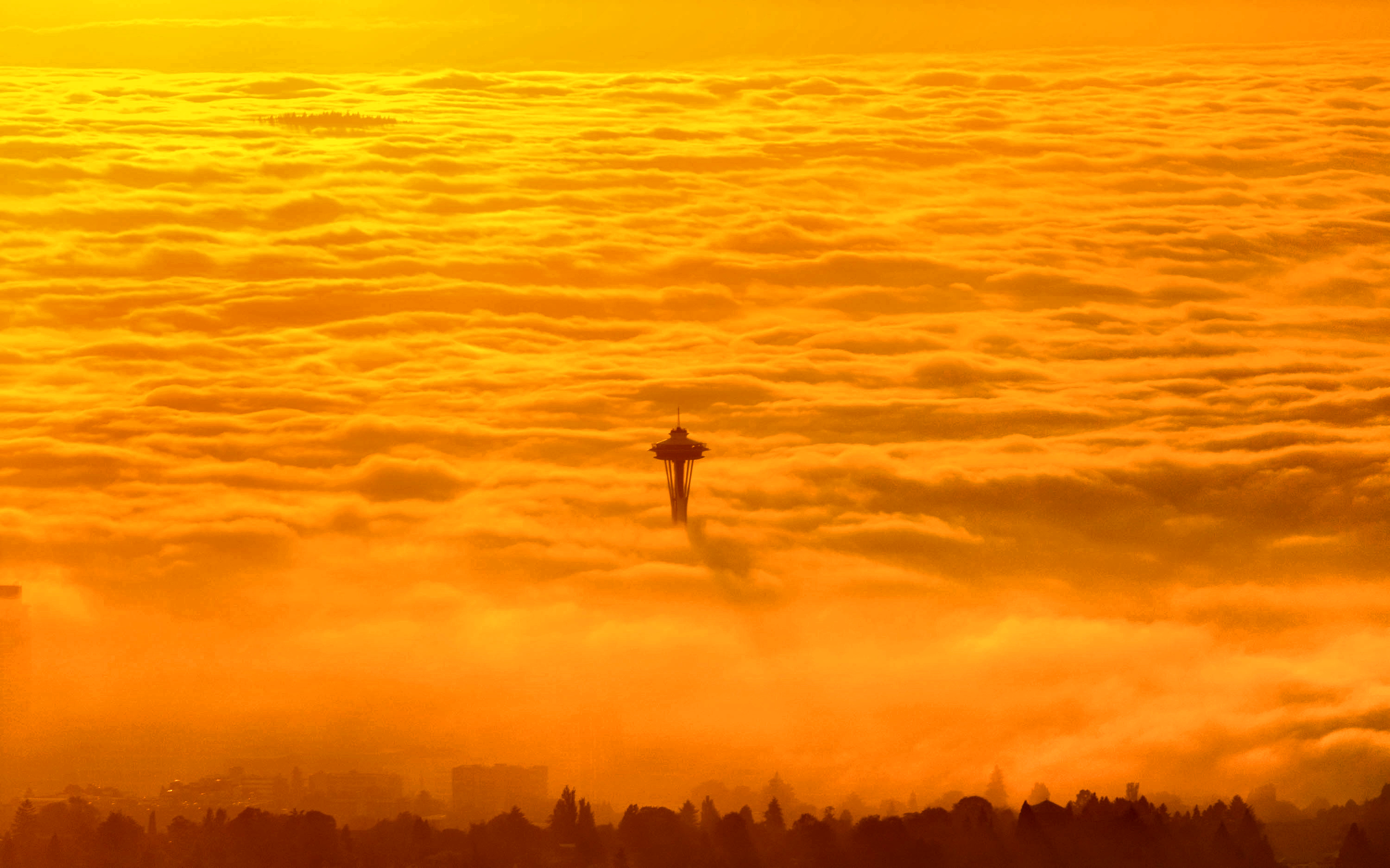 Aerial photo of Space Needle protruding from a fog bank Seattle Washington