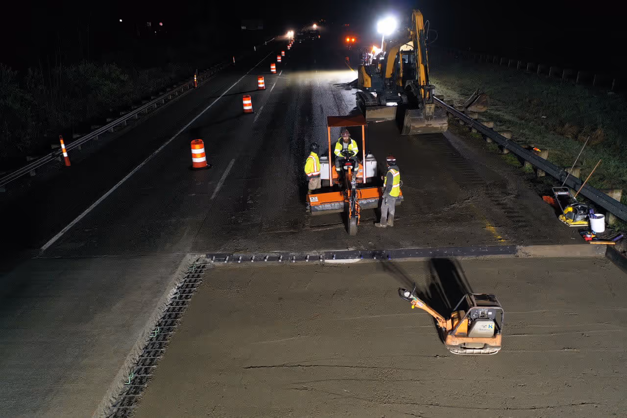 A nighttime aerial photo of a freeway construction project