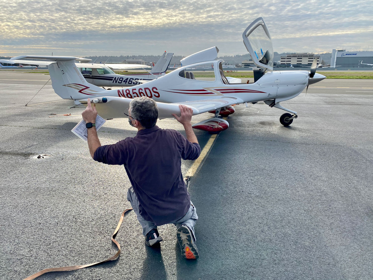 A man preflighting a Diamond DA-20 airplane
